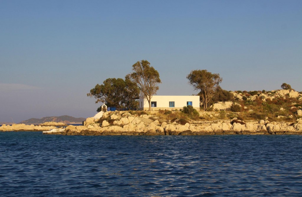 Small Island by Mandraki Bay with Typical Greek House