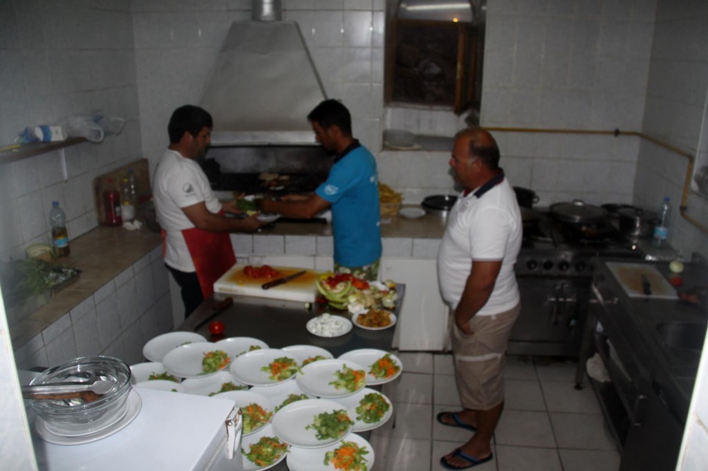 The Cooks Look Busy in the Restaurant Kitchen