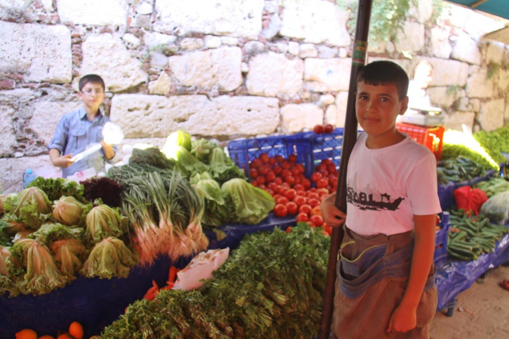 Two Young Assistants Serving on the Vegetable Stall