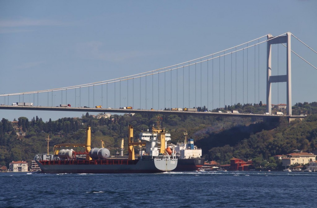 Two Large Ships Travel North Uncomfortably Close Beneath the Bridge