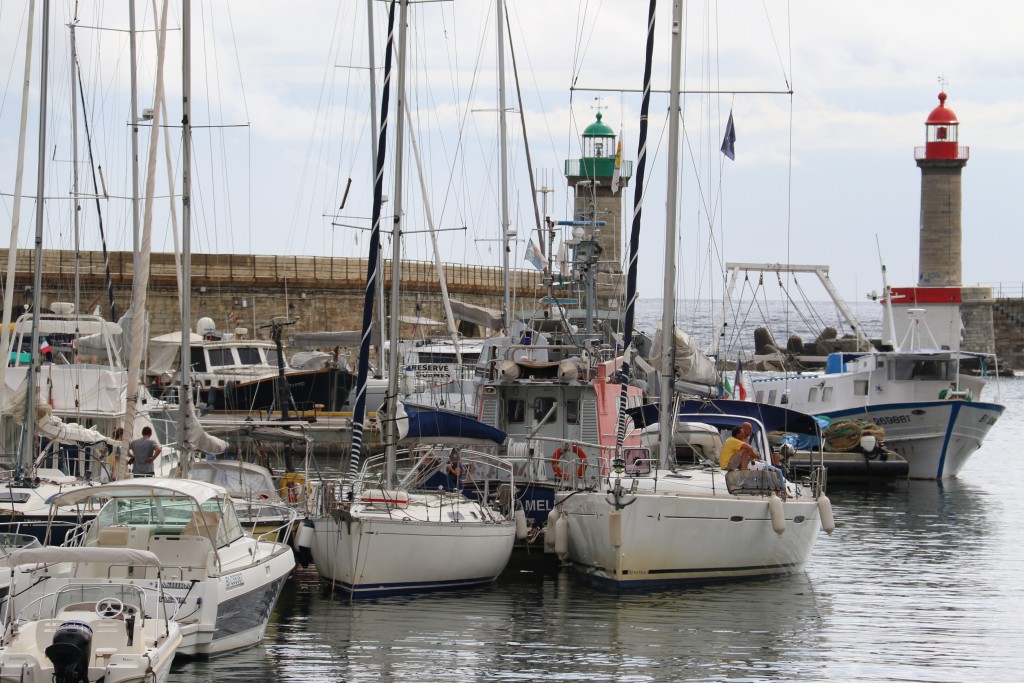 We capture a glimpse of the Tangaroa through the yachts moored in the port