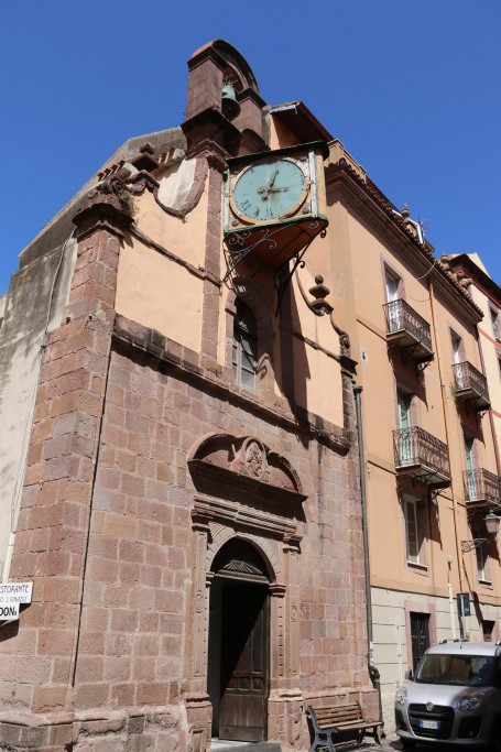 The little Church of the Rosario, with its characteristic prejoceting two-faced clock and a high bell tower