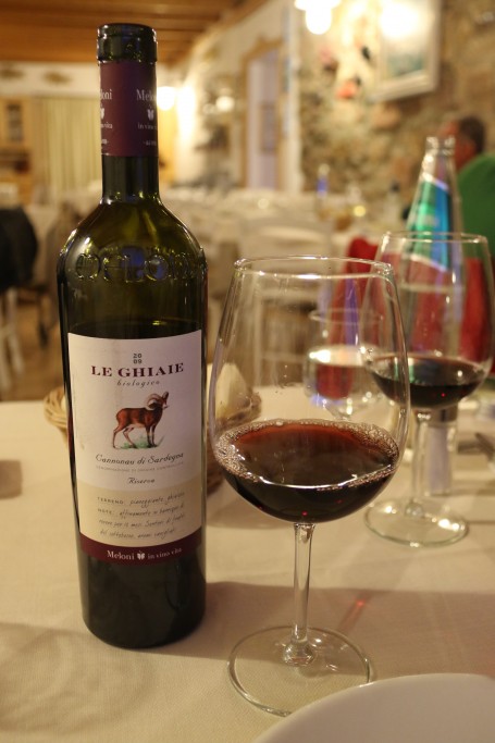 We order some Sardinian vino rosso